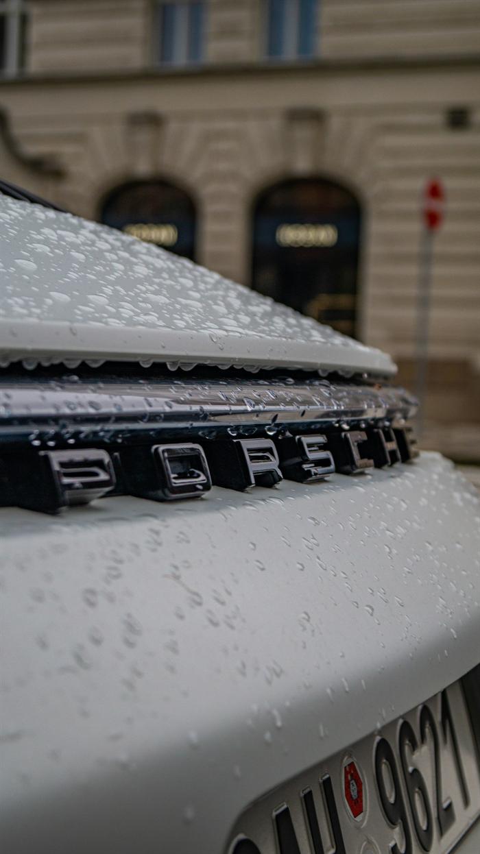 Water beading on freshly coated paint around a rear badge