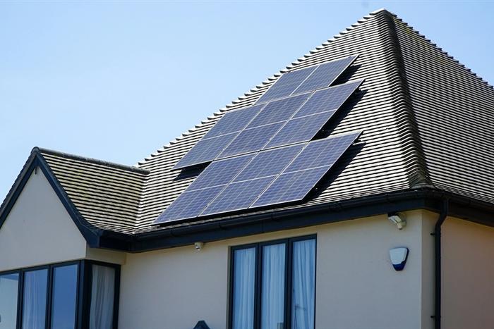 A house with a solar panel array on the pitched roof